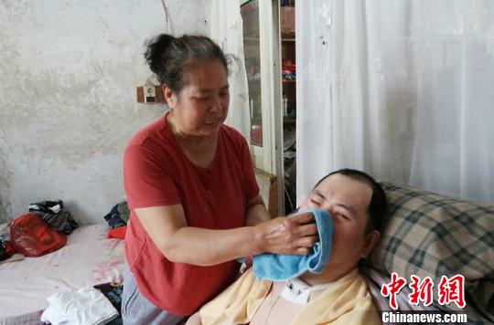 每次喂完食物后，梁青蘭都要仔細(xì)地幫兒子清理干凈?！∩忻鱾b 攝
