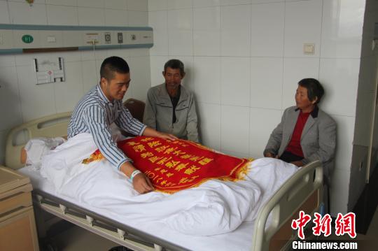 被救的李忠起、張總鳳夫婦看望受傷后的李運(yùn)飛?！⊥粲?攝